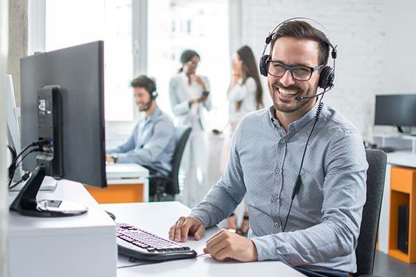 Smiling insurance advisor on the phone to a client