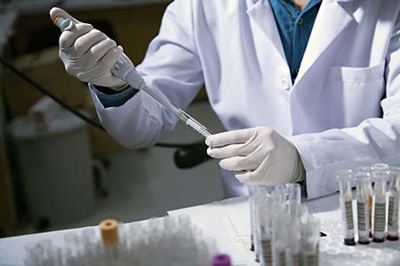 Phlebotomist at work with various blood samples in test tubes