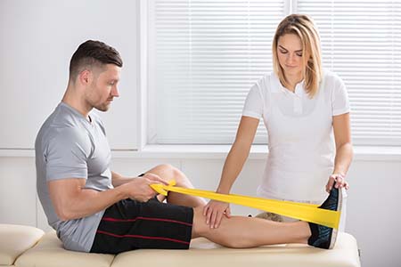 Physiotherapist using different techniques to help a patient recover