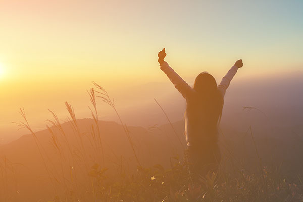 Person feeling stree-free enjoying a sunset